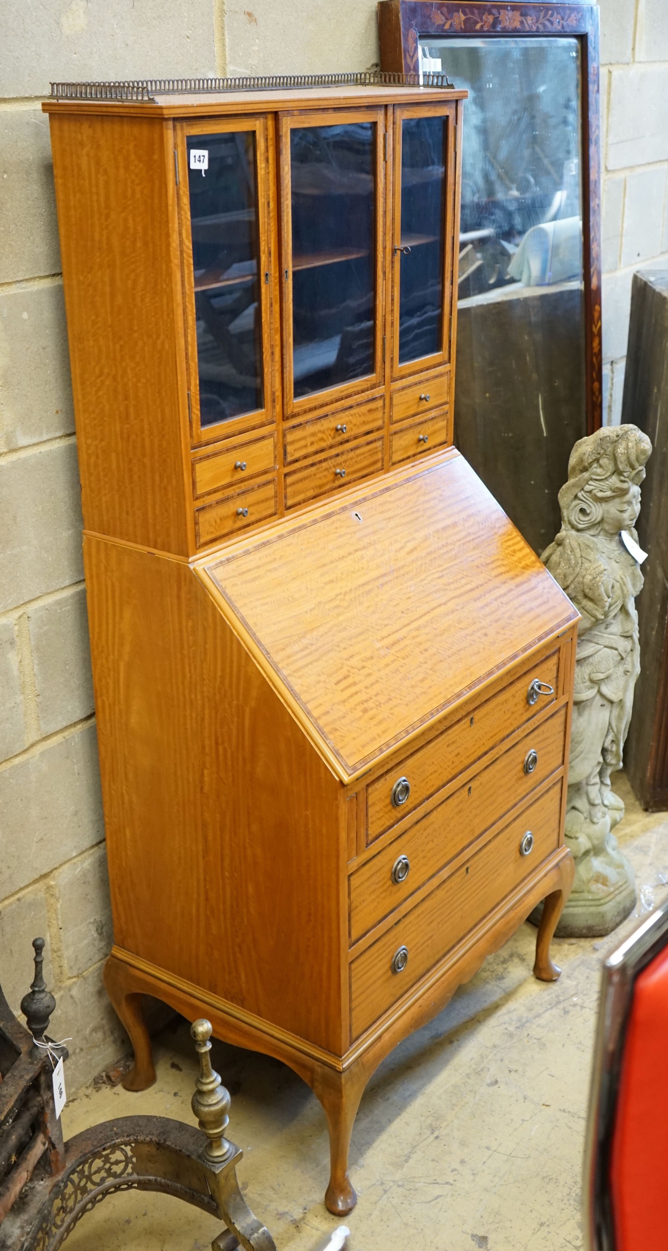 An Edwardian satinwood bureau bookcase, width 69cm, depth 47cm, height 160cm (lock a.f)